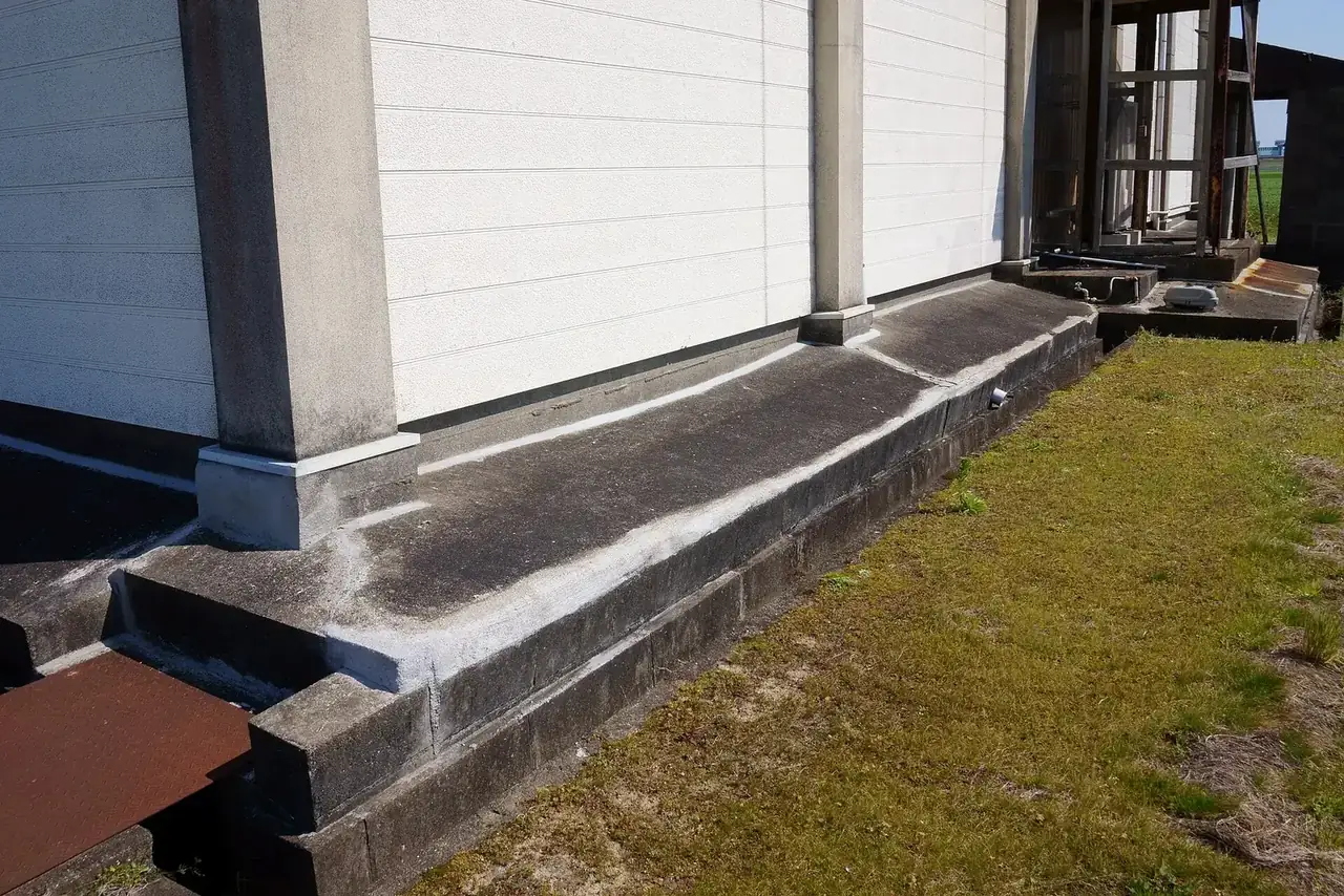 Where the foundation meets the soil line outside a house.